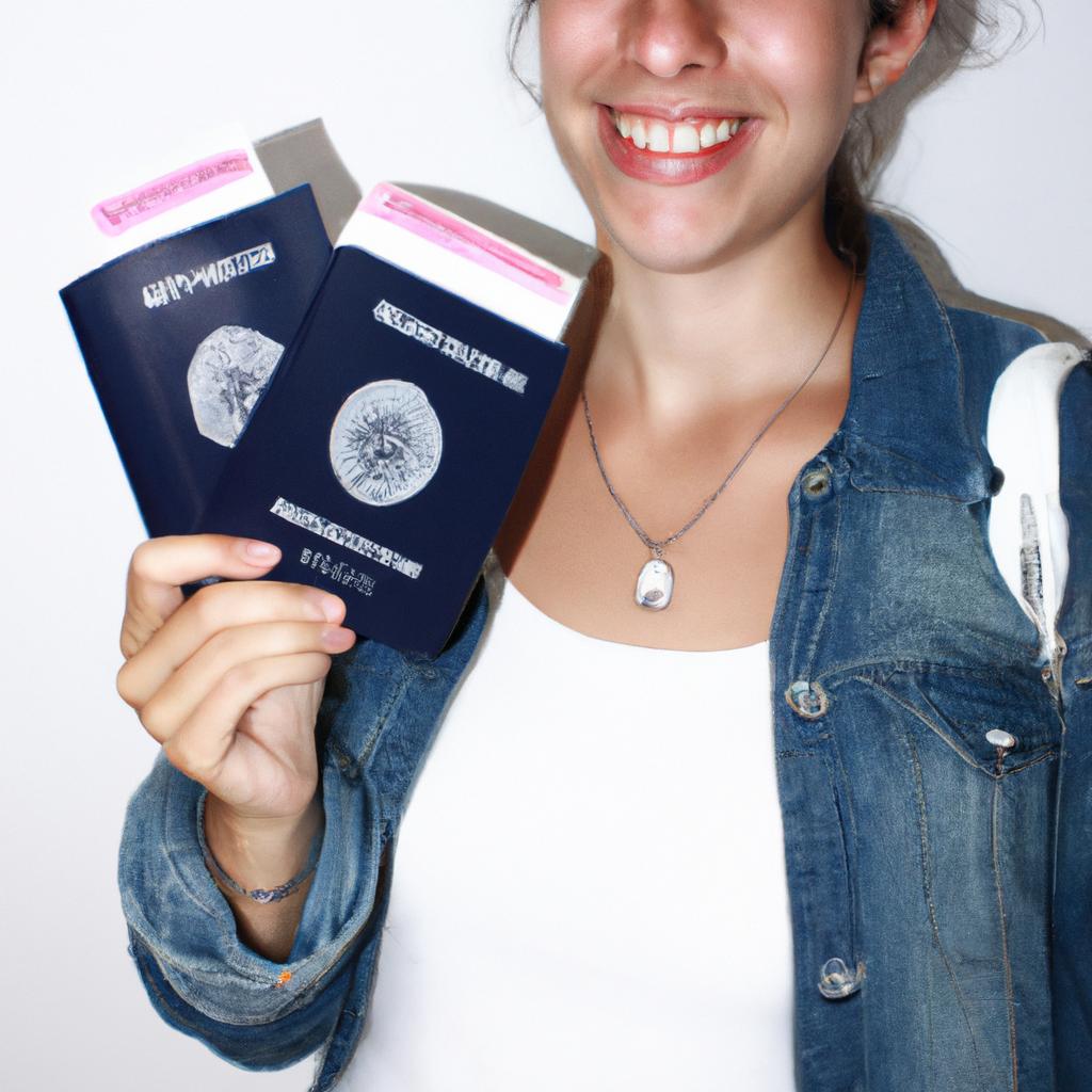 Person holding travel documents, smiling